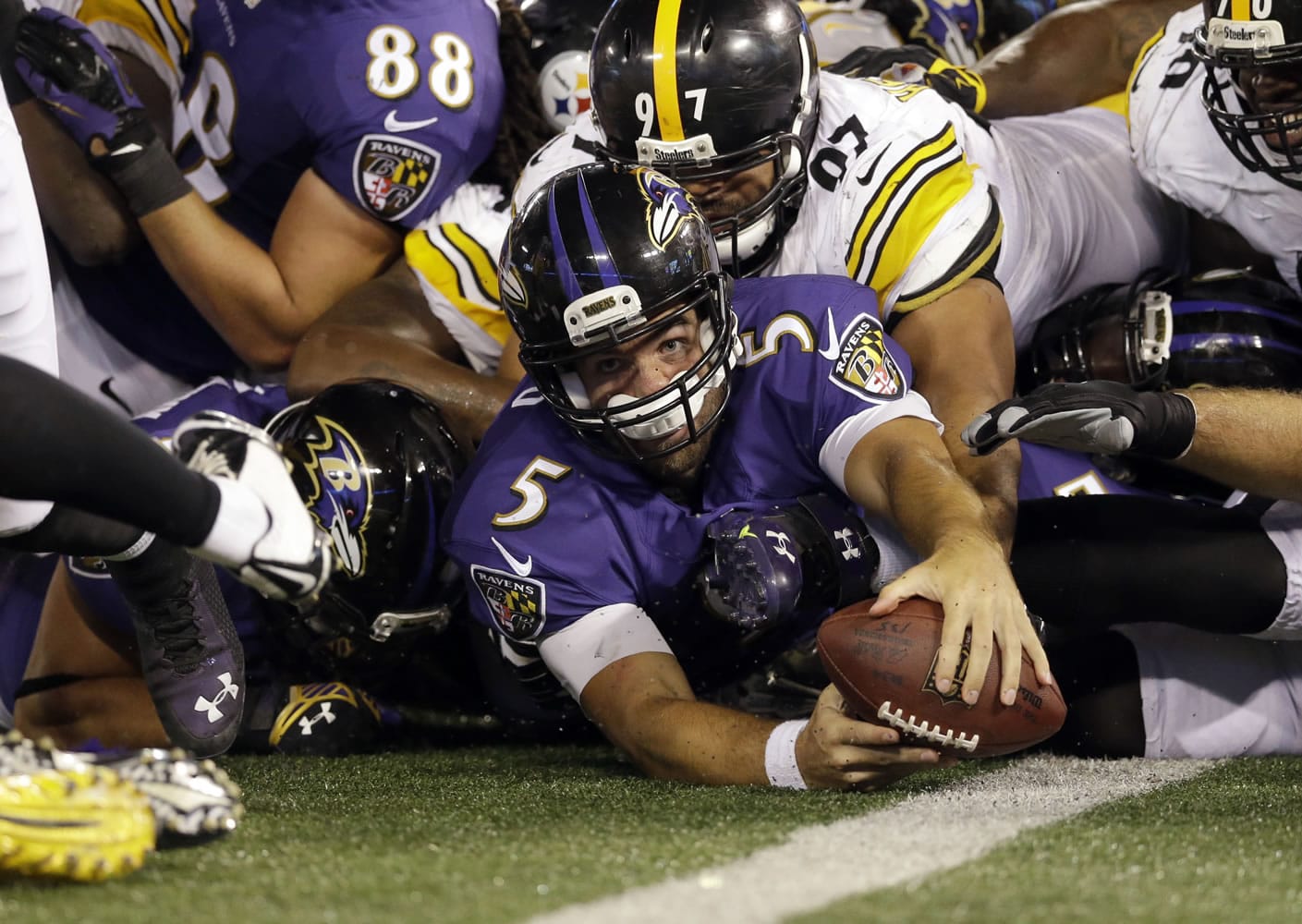 Baltimore Ravens quarterback Joe Flacco (5) is just short of a touchdown as he is hit by Pittsburgh Steelers defensive end Cameron Heyward (97) and other defenders during the second half Thursday, Sept. 11, 2014, in Baltimore. The Ravens won 26-6.