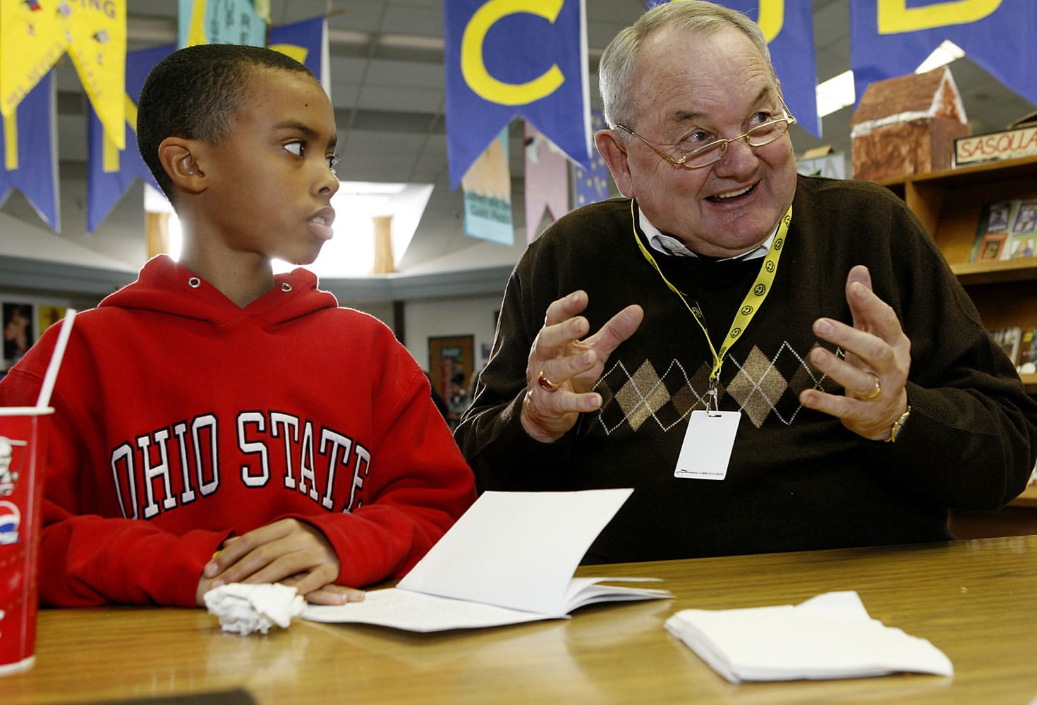 Isaiah Ephraim, then a fifth-grader at Martin Luther King Elementary School in Vancouver, listens as Steve Runyan, a volunteer Lunch Buddy, talks about Patrick McManus' story &quot;Blood Sausage&quot; in February 2008. The two had been lunch buddies since Isaiah was in third grade.