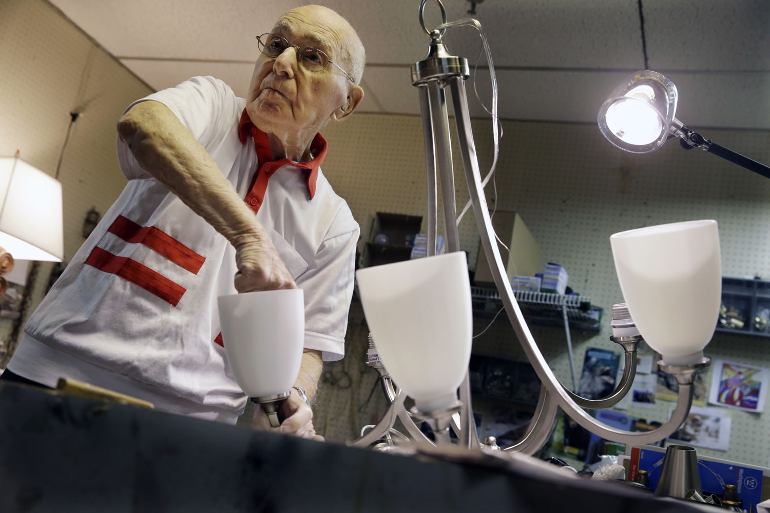 Lighting repair specialist Herman &quot;Hy&quot; Goldman, 101, refurbishes a light fixture in his workshop at Capitol Lighting where he has worked for 73 years on Monday in East Hanover, N.J.