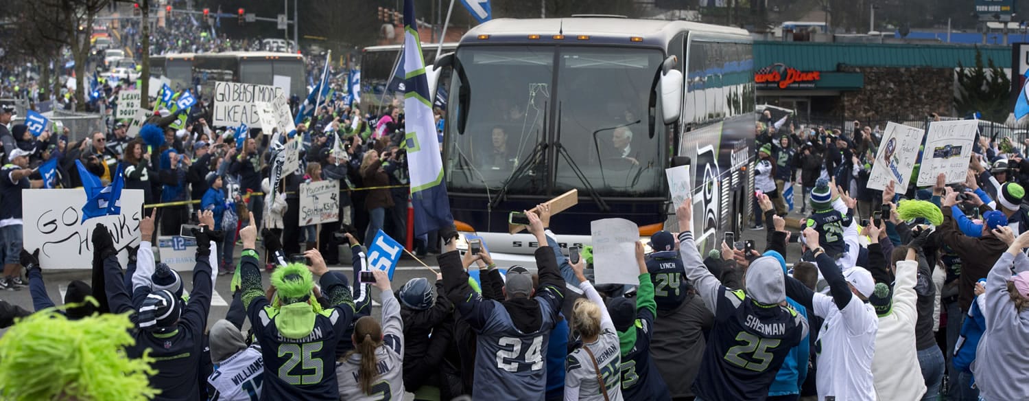 A huge crowd in SeaTac gives a rousing send-off to the Seattle Seahawks while the team buses go by on the way to the Sea-Tac International Airport.