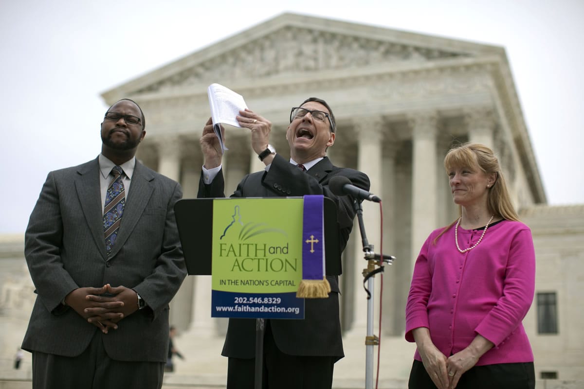 Reverend Dr. Rob Schenck, of Faith and Action, center, speaks in front of the Supreme Court with Raymond Moore, left, and Patty Bills, both also of Faith and Action, during a news conference Monday inn Washington.