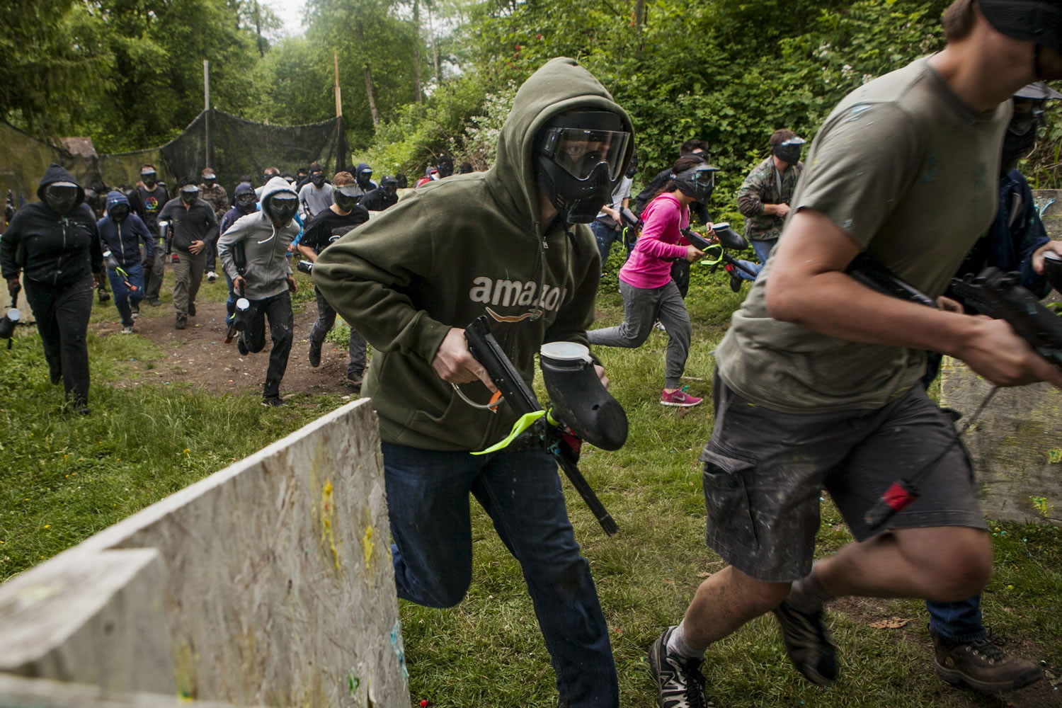Interns from Amazon charge off in a June 15 paintball match versus interns from Microsoft at Eastside Paintball in Monroe.