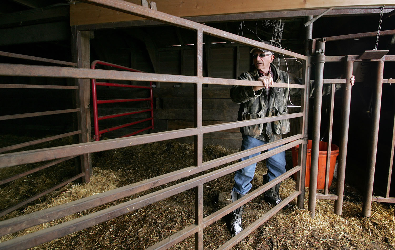 Tom Soukup opens a gate inside the barn where he was pinned to a wall by a cow on his Wagner, S.D., ranch in 2010.