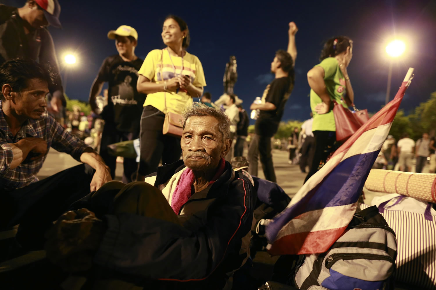 Thai anti-government protesters wait for city bus to transport them to the bus terminal at Royal Plaza in Bangkok, Thailand, on Thursday.