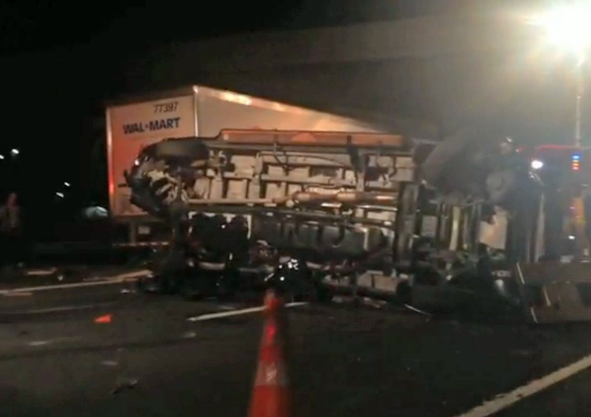 The limousine bus carrying Tracy Morgan and six other people lies on its side early Saturday morning on the New Jersey Turnpike.