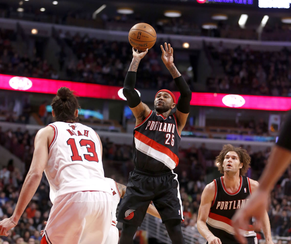 Portland Trail Blazers guard Mo Williams (25) shoots over Chicago Bulls center Joakim Noah (13) as Robin Lopez watches during the second half of an NBA basketball game Friday, March 28, 2014, in Chicago. The Trail Blazers won 91-74.