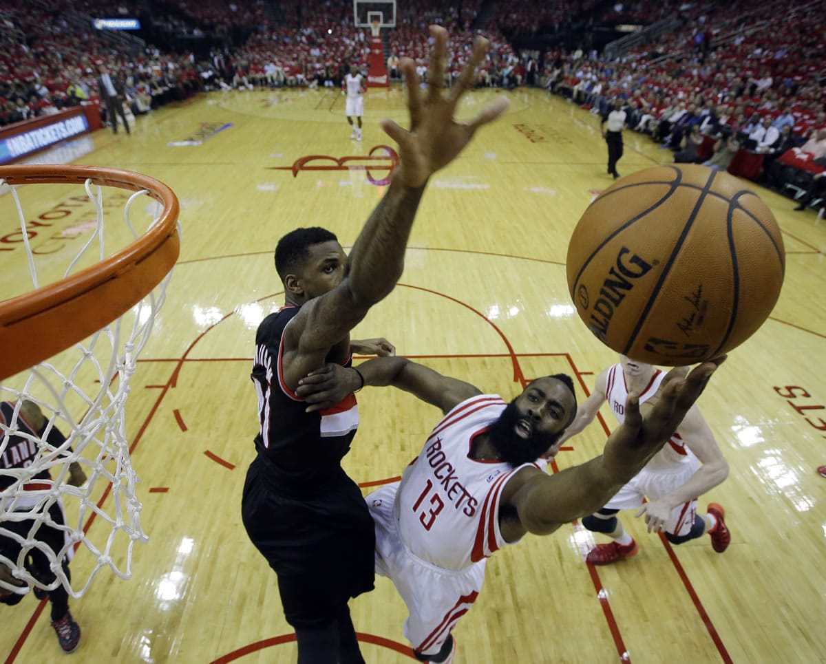 Houston Rockets' James Harden (13) put sup a shot against Portland Trail Blazers' Thomas Robinson (41) during the first half in Game 2 of an opening-round NBA basketball playoff series Wednesday, April 23, 2014, in Houston. (AP Photo/David J.