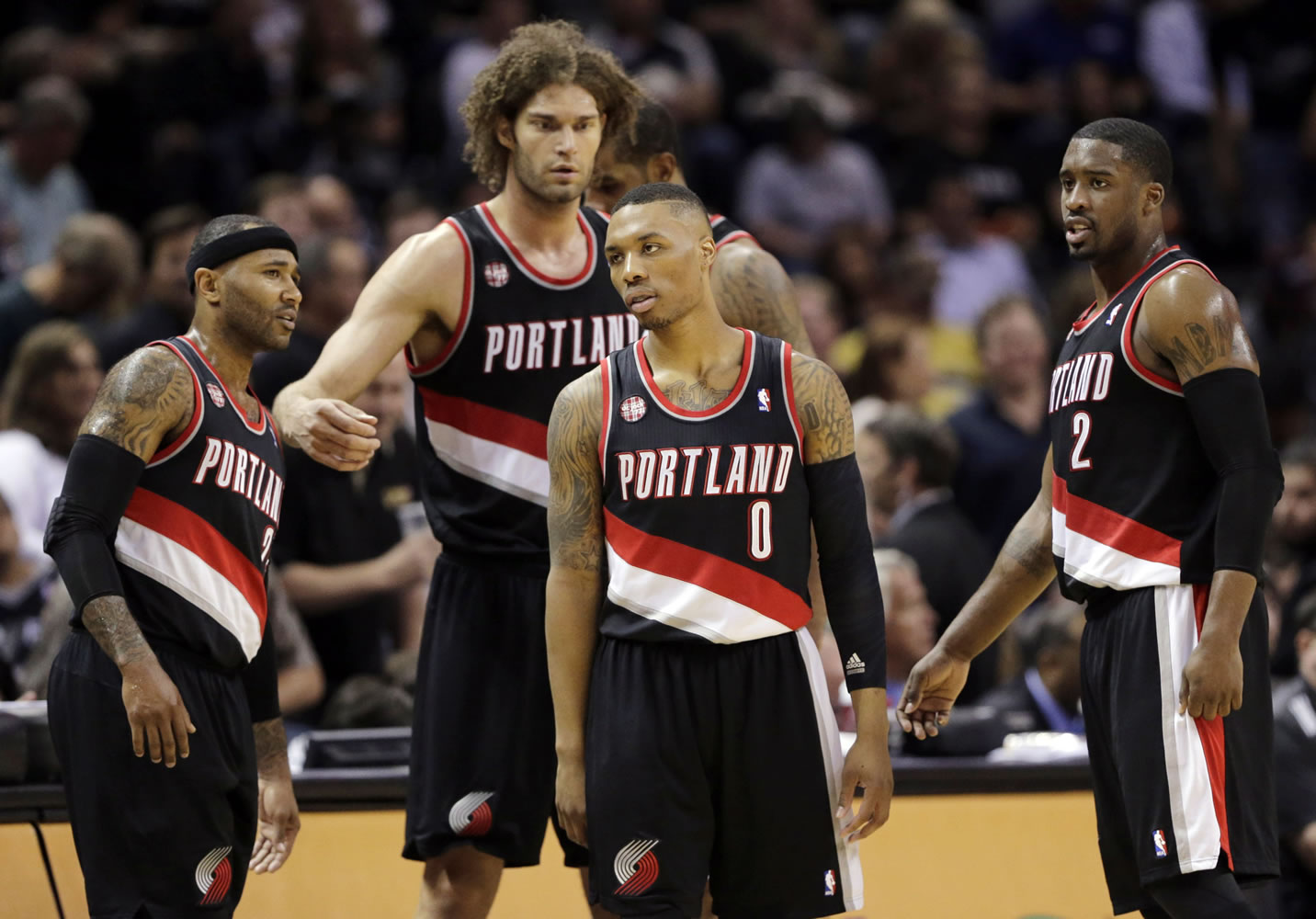 Portland Trail Blazers' Damian Lillard (0) and teammates wait to enter the game following a timeout during the first half of Game 1 of a Western Conference semifinal NBA basketball playoff series against the San Antonio Spurs, Tuesday, May 6, 2014, in San Antonio.
