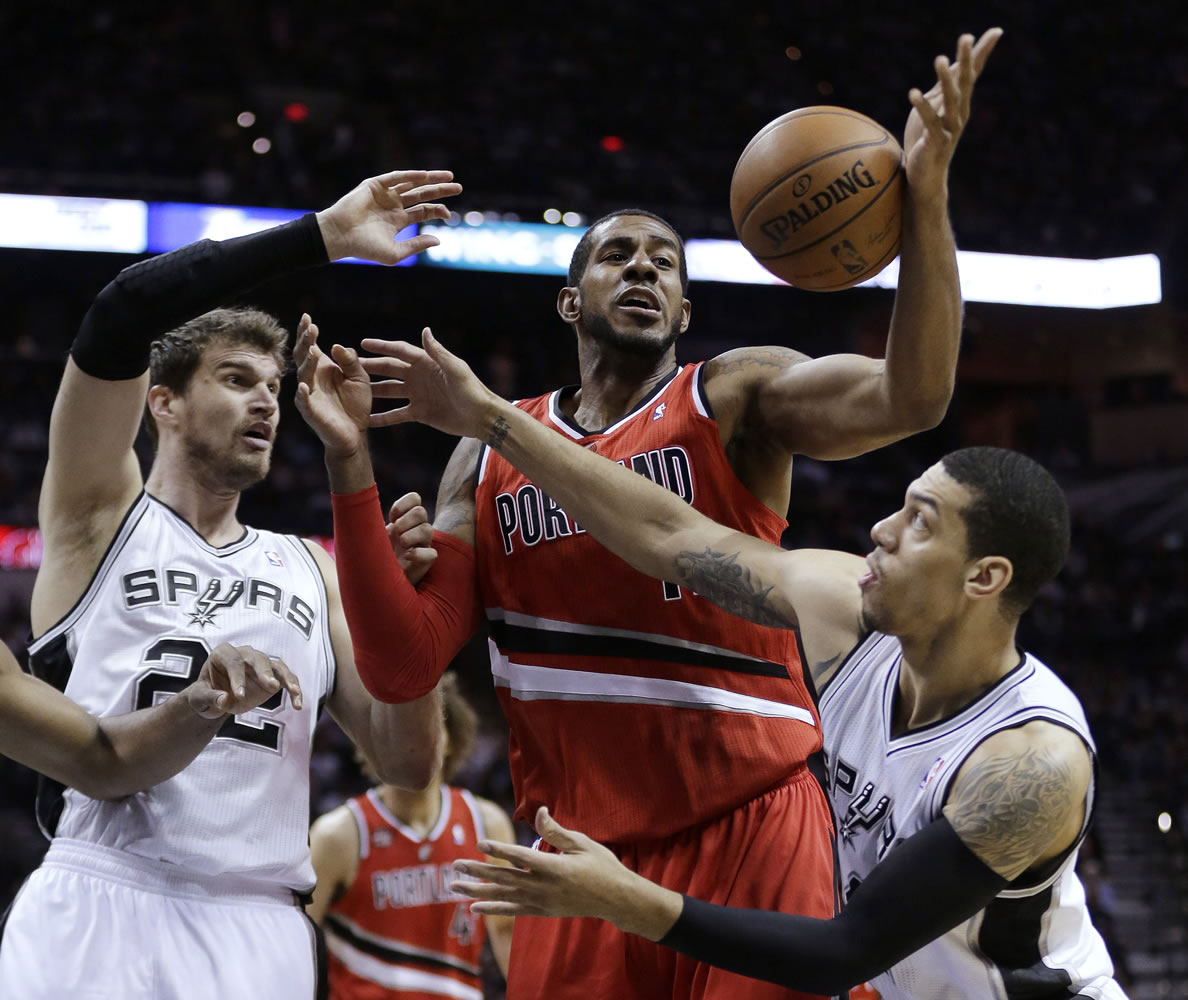 Portland Trail Blazers' LaMarcus Aldridge, center, vies with San Antonio Spurs' Tiago Splitter (22) and Danny Green, right, for a rebound during the first half of Game 5 Wednesday in San Antonio.
