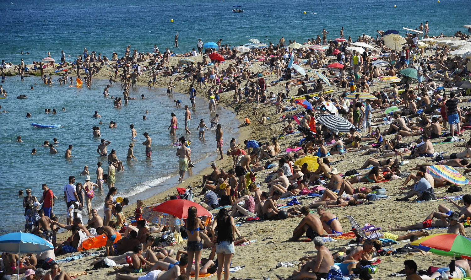 People relax on the beach on July 17 in Barcelona, Spain.