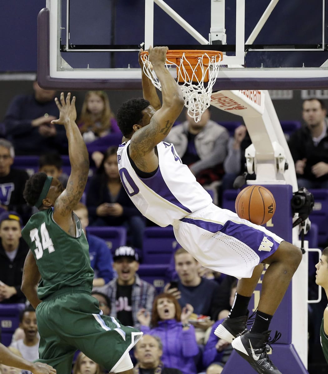 Washington's Shawn Kemp Jr., right, dunks in front of Tulane's Tre Drye during the first half Monday, Dec. 22, 2014, in Seattle.