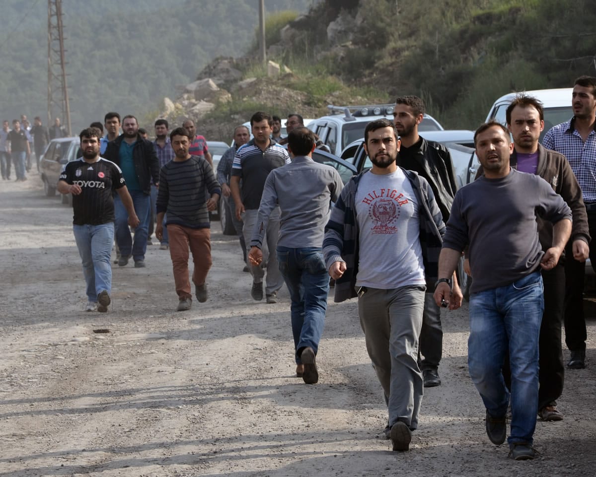Workers and relatives arrive after an explosion and fire at a coal mine in Soma, in western Turkey, on Tuesday.