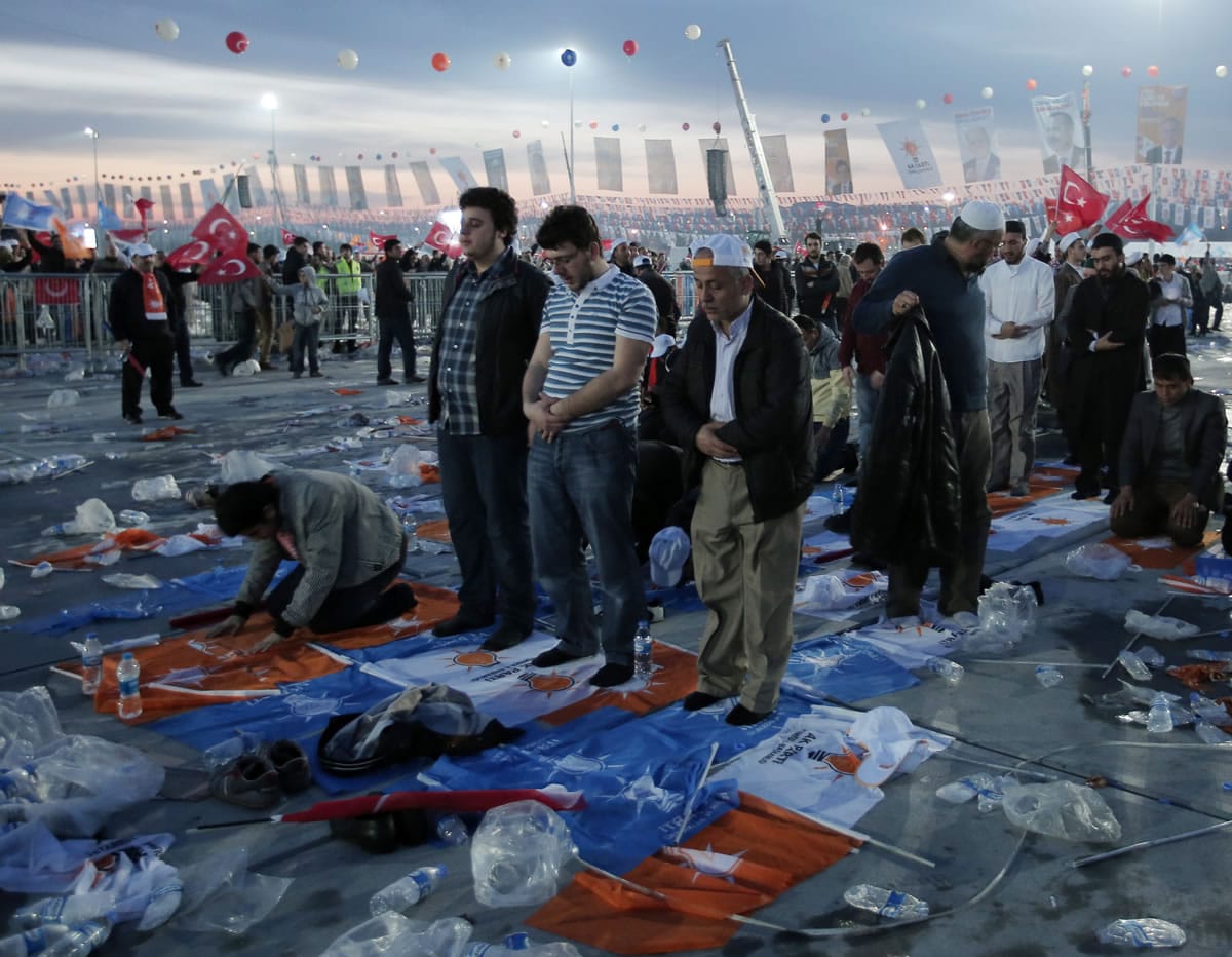 The supporters of Turkish Prime Minister Recep Tayyip Erdogan pray after a rally of his Justice and Development Party in Istanbul, Turkey, Sunday, March 23, 2014. Turkish fighter jets shot down a Syrian warplane after it violated Turkey's airspace Sunday, Erdogan said, in a move likely to ramp up tensions between the two countries already deeply at odds over Syria's civil war.