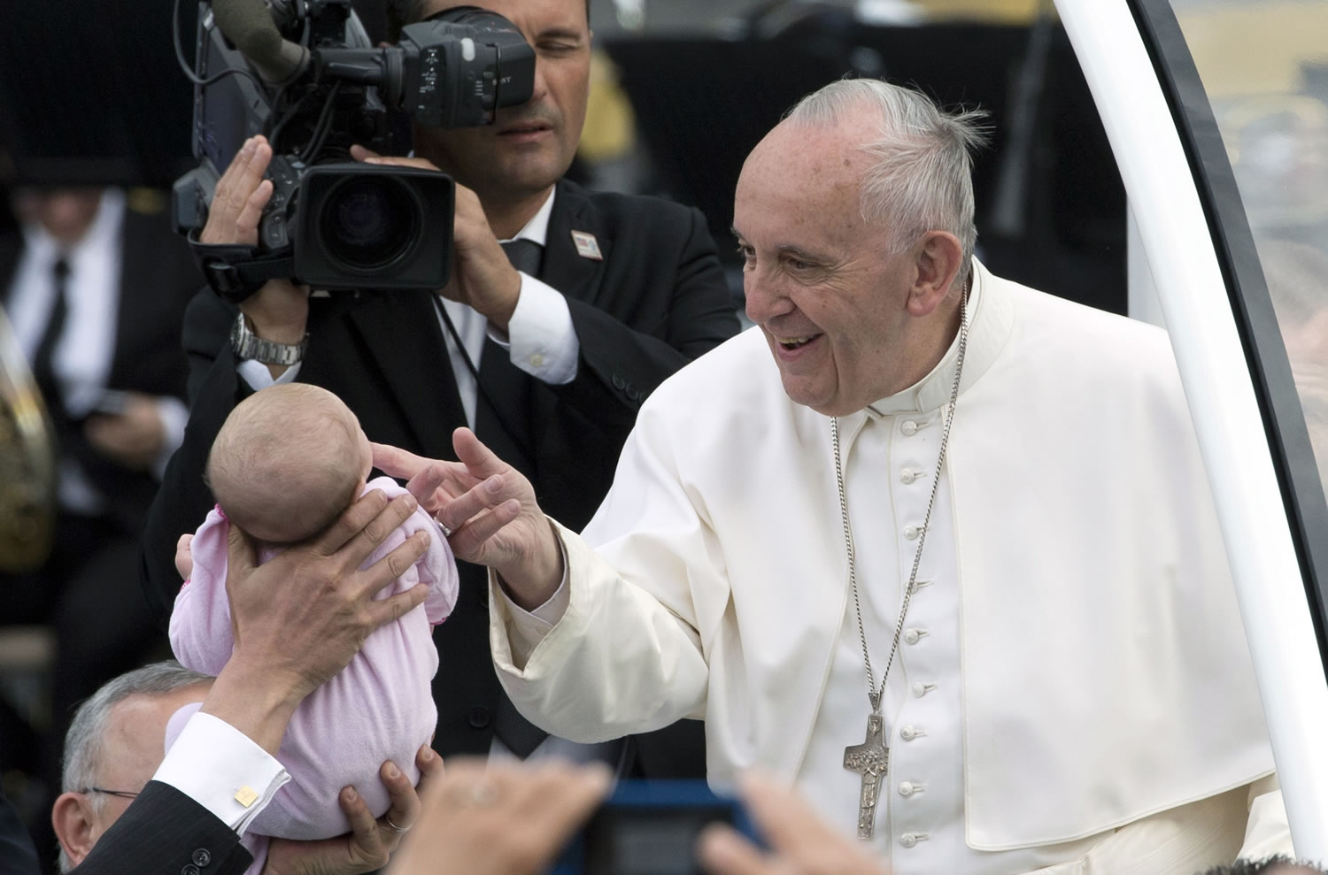 Pope Francis greets a baby as he arrives to Independence Mall, on Saturday, before delivering a speech in front of Independence Hall, in Philadelphia.