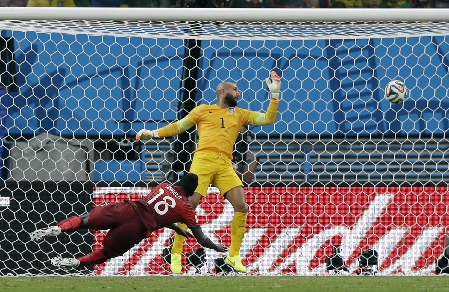 Portugal's Silvestre Varela heads the ball past United States' goalkeeper Tim Howard to score his side's second goal and tie the game 2-2 during the group G World Cup soccer match between the USA and Portugal at the Arena da Amazonia in Manaus, Brazil, Sunday, June 22, 2014.