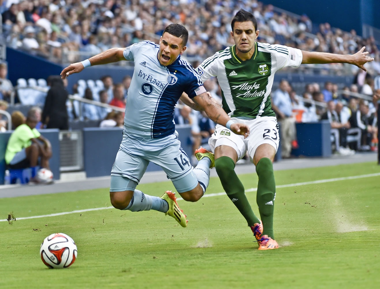 Sporting Kansas City forward Dom Dwyer (14) draws a penalty from Portland Timbers defender Norberto Paparatto (23) during the first half of a U.S.