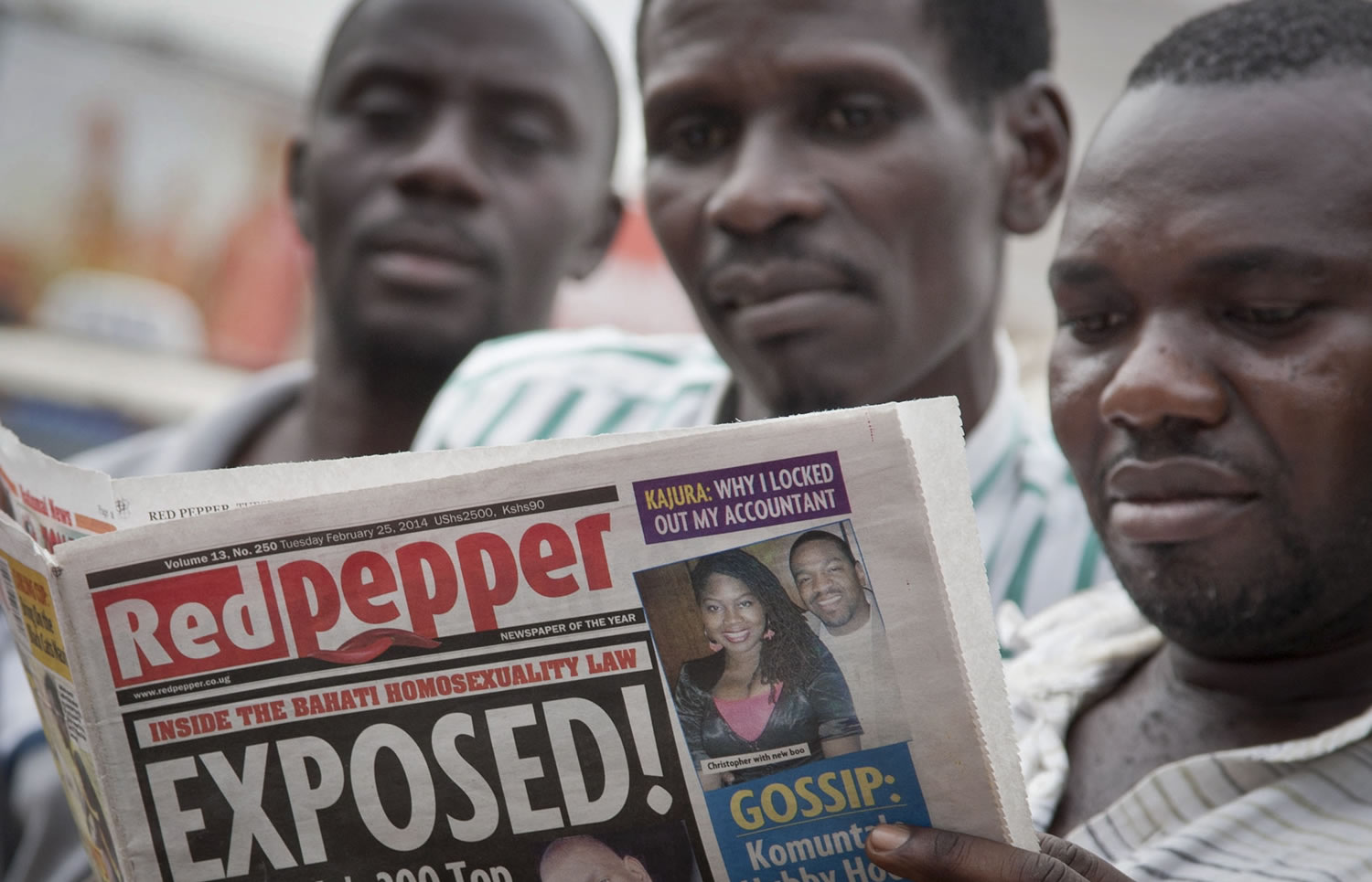 A Ugandan reads a copy of the &quot;Red Pepper&quot; tabloid newspaper in Kampala, Uganda, on Tuesday.