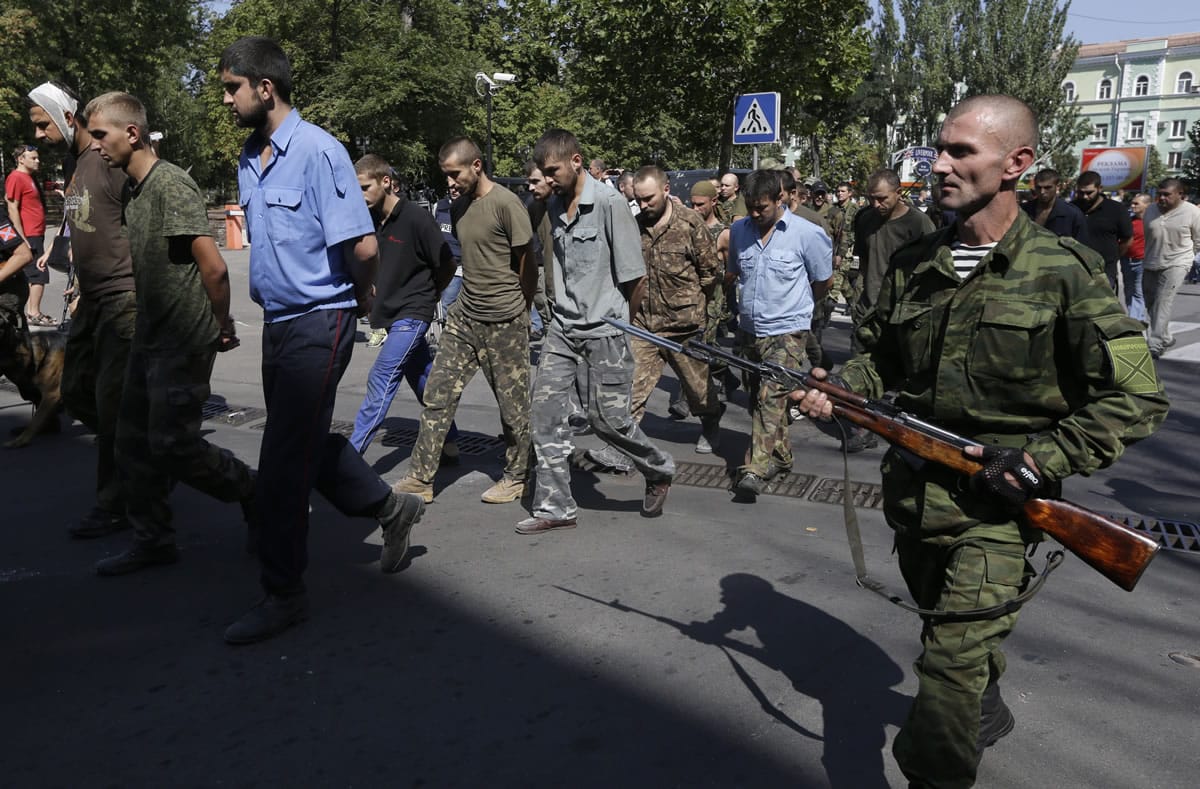 Pro-Russian rebels escort captured Ukrainian army prisoners Sunday on central square in Donetsk, eastern Ukraine.