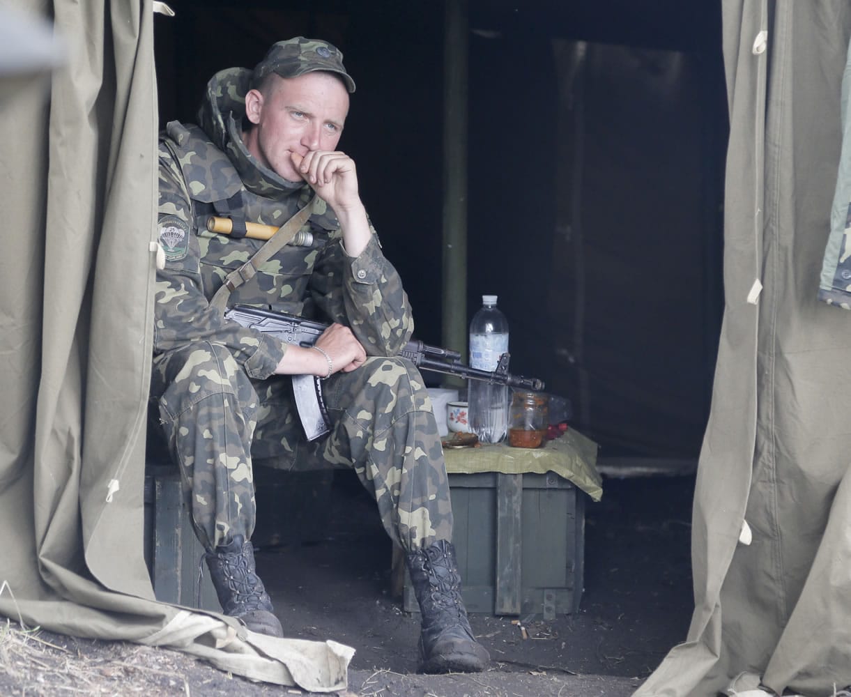 A Ukrainian soldier take a rest at a checkpoint Friday outside Slovyansk, Ukraine.