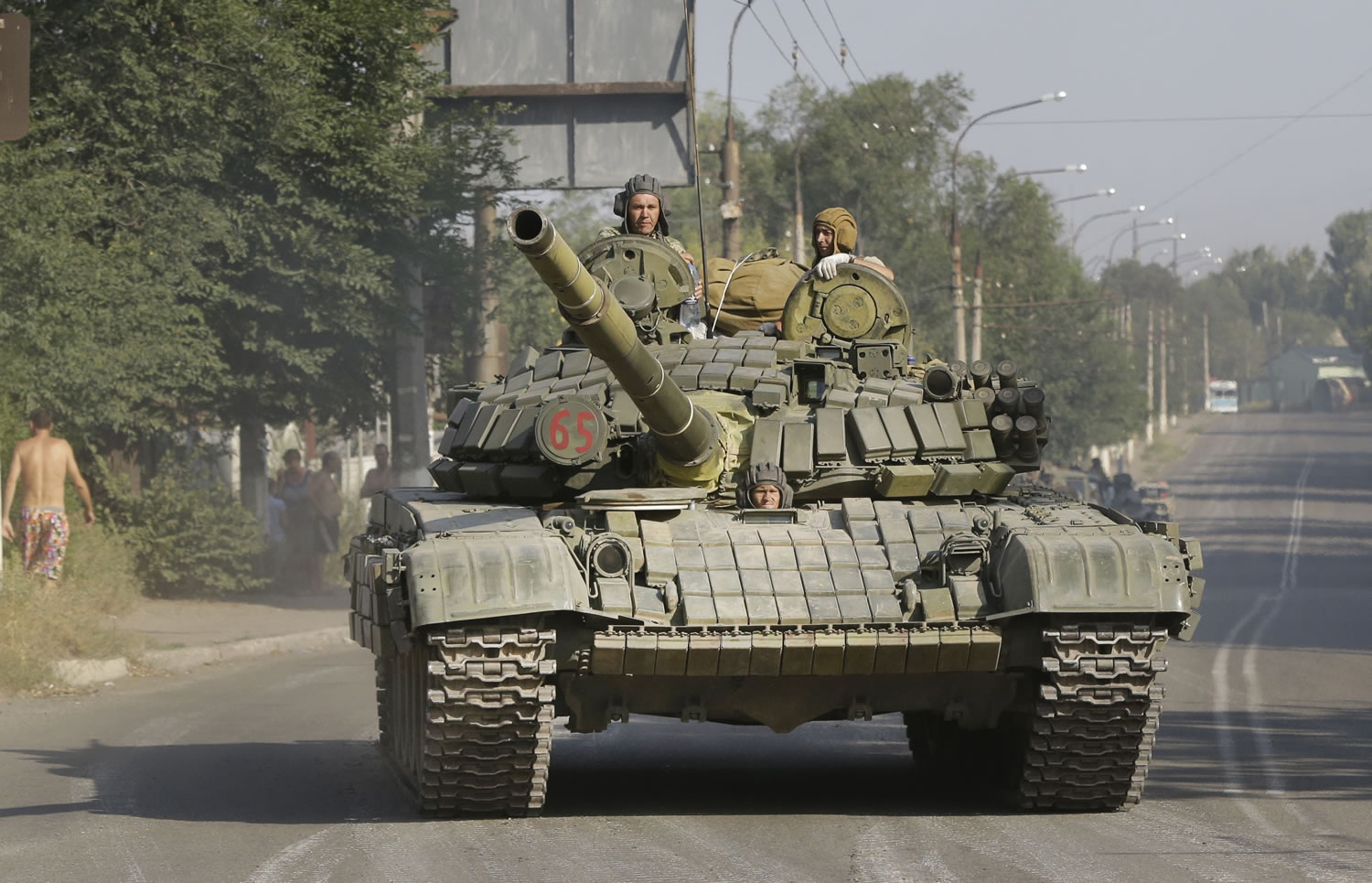 Pro-Russian rebels ride on a tank Sunday in the town of Krasnodon, eastern Ukraine.