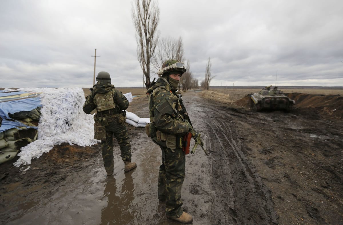 Ukrainian government army soldiers at a check-point near the village of Debaltseve, Donetsk region, eastern Ukraine Wednesday, Dec 24, 2014. Peace talks aimed at reaching a stable cease-fire in Ukraine between its government forces and pro-Russian armed groups began on Wednesday in Minsk, Belarus, with the discussions to include a pullout of heavy weapons and an exchange of war prisoners.