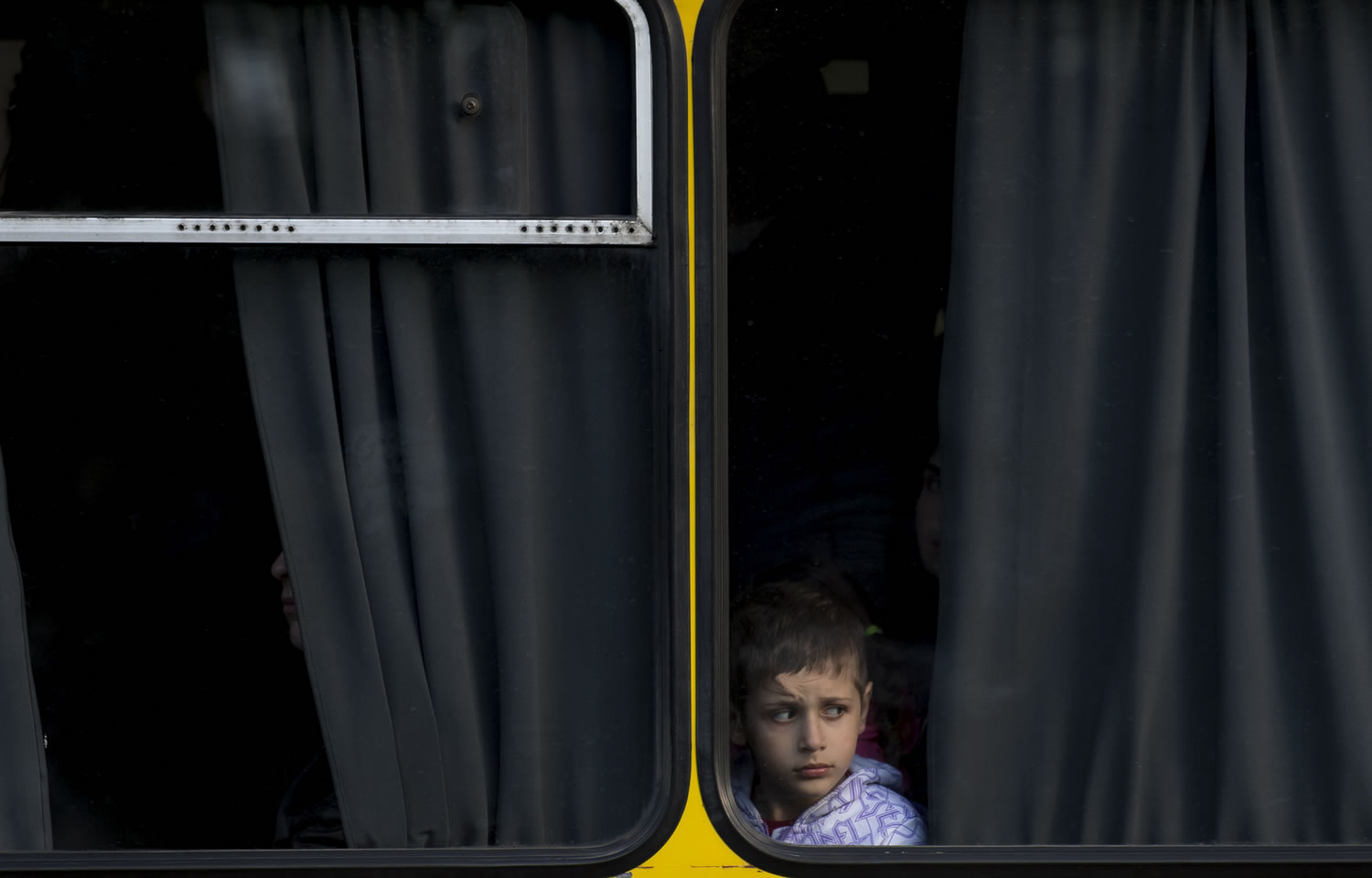A child looks out from a bus in Odessa, Ukraine, on Tuesday.