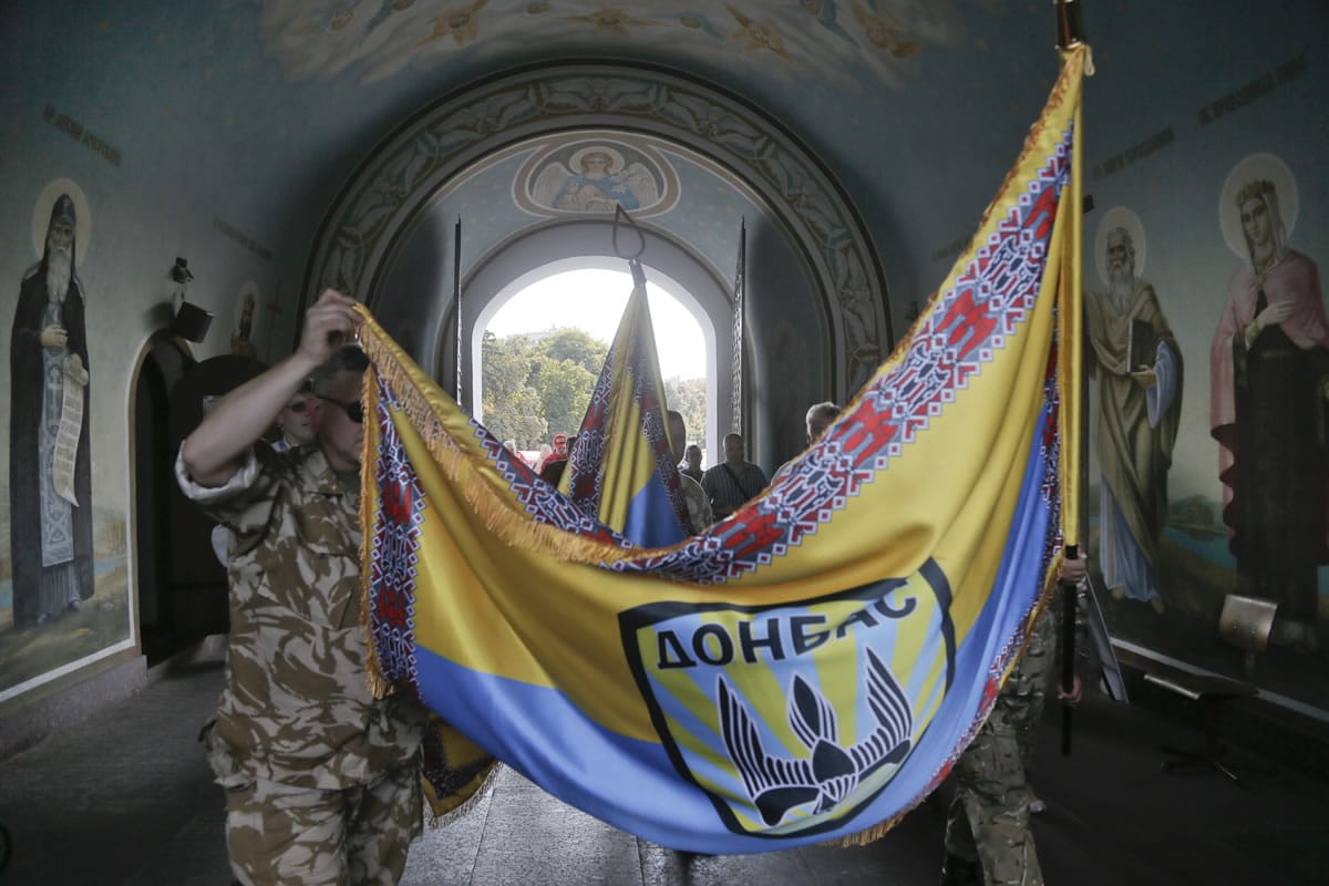 Volunteers of battalion 'Donbas'  carry battalion colours during blessing ceremony in St.