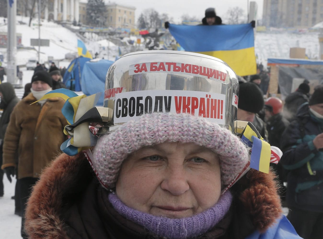 A pro-European Union activist, wearing a saucepan on her head as a protection helmet, attends a rally Wednesday in Independence Square in Kiev, Ukraine.