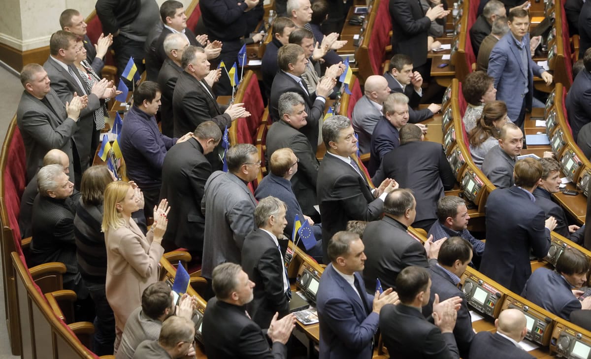 Ukrainian lawmakers applaud after voting during a parliamentary session in Kiev, Ukraine, on Tuesday.
