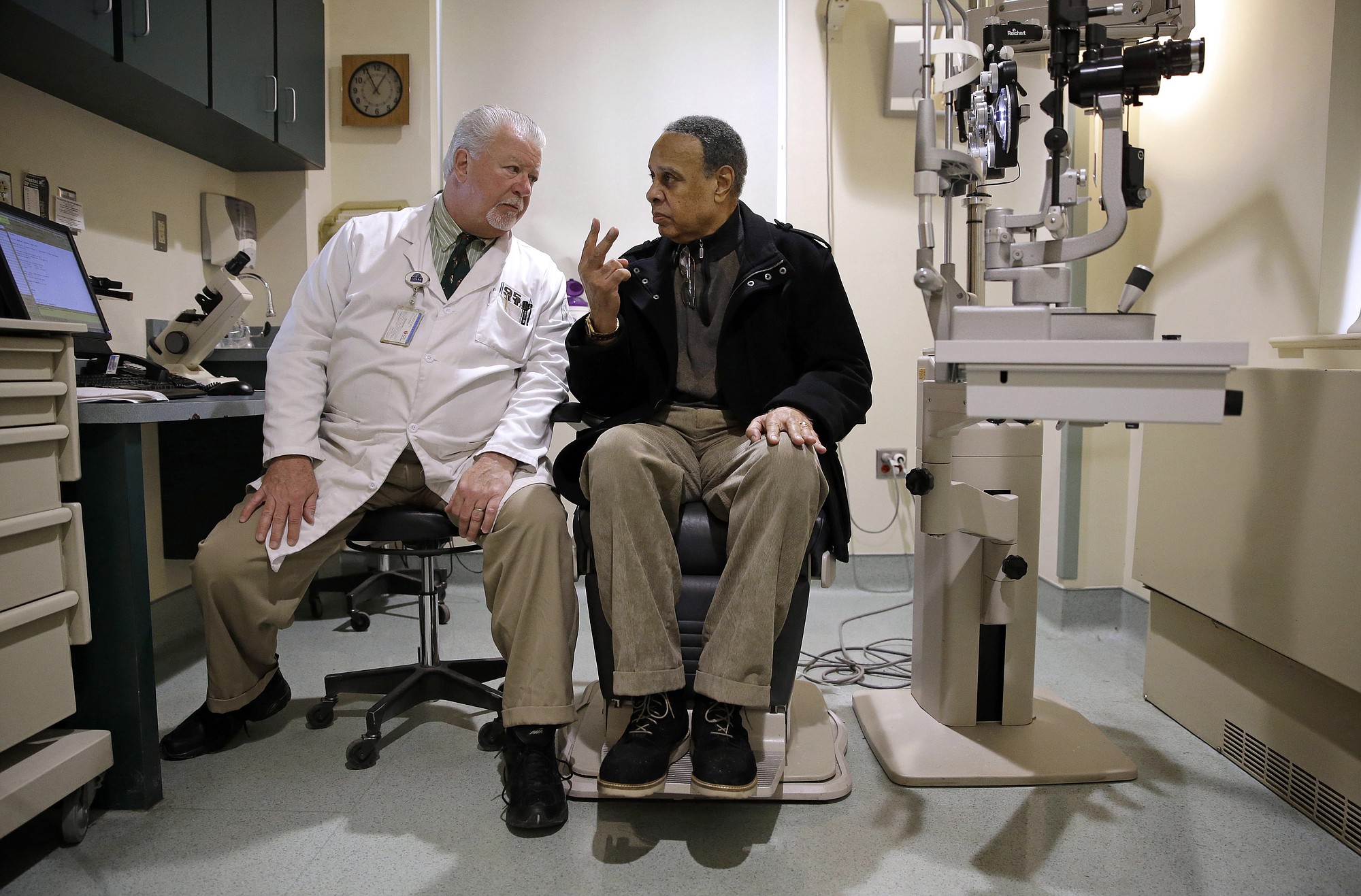 Optometrist Paul Archambault, left, talks with U.S.