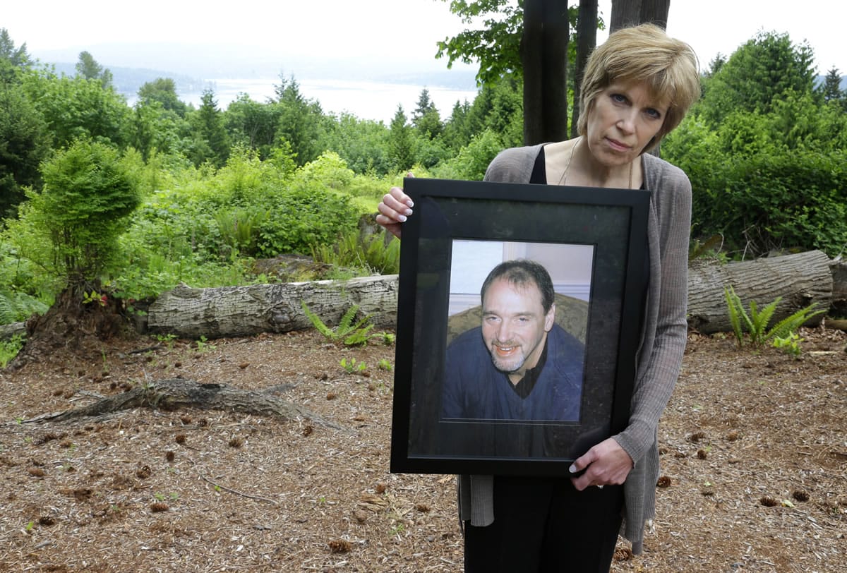 Connie Olberg holds a photo of her brother, Donald Douglass, who had a small spot diagnosed as cancerous at the Seattle Veterans Affairs hospital in 2011.