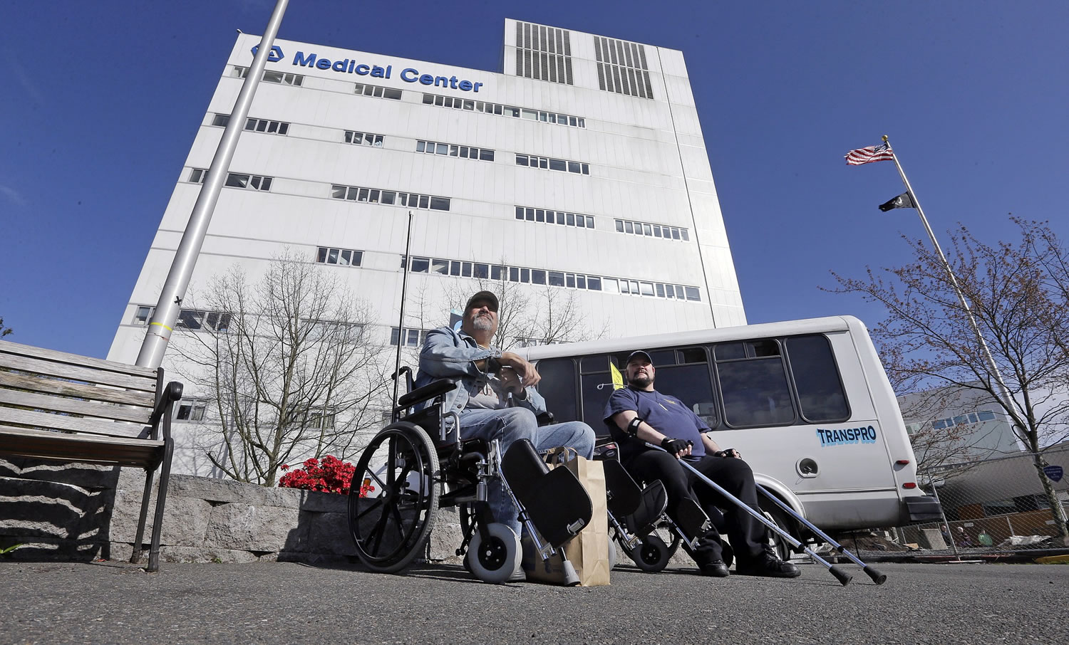 Army veteran Michael Thrun, left, and Navy veteran Thomas Berry sit in wheelchairs as they wait for their rides following treatment at the Veterans Administration Puget Sound Medical Center in Seattle.