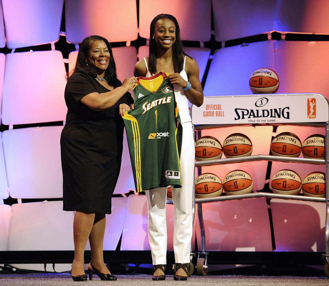 Notre Dame's Jewell Loyd, right, holds up a Seattle Storm jersey with WNBA president Laurel J. Richie after the Storm selected Loyd as the No. 1 pick in the WNBA basketball draft, Thursday, April 16, 2015, in Uncasville, Conn.