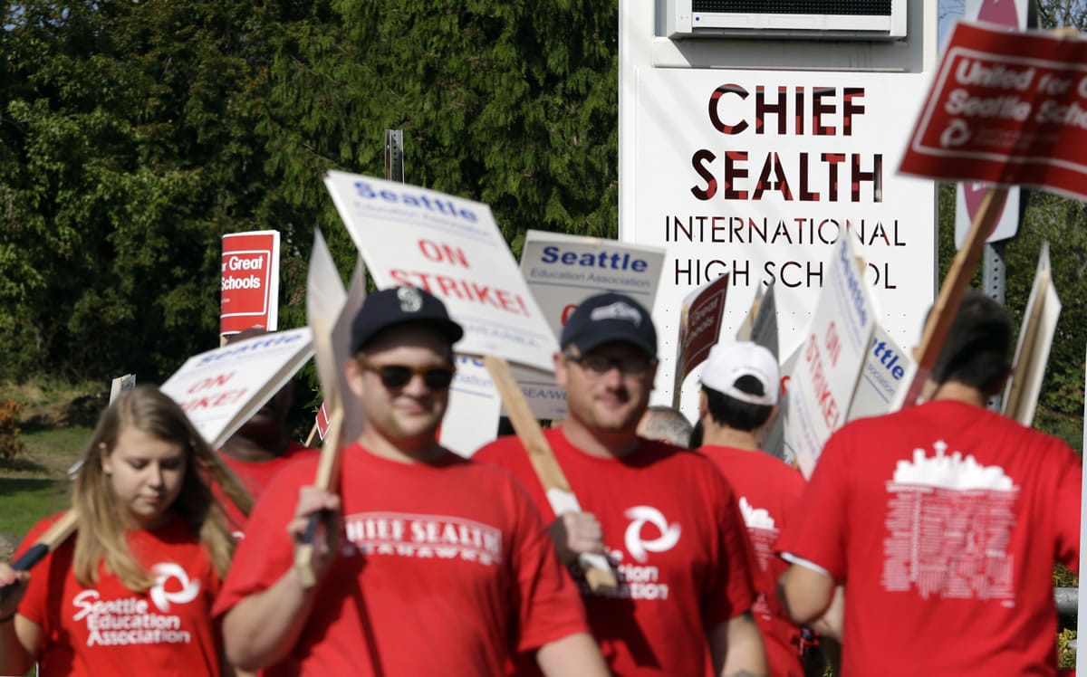 Teachers walk a picket line in front of Chief Sealth International High School Wednesday in Seattle. Teachers in Seattle began walking picket lines Wednesday after last-minute negotiations over wages and other issues failed to avert a strike in Washington state's largest school district. Classes for 53,000 Seattle Public Schools students were canceled Wednesday, on the scheduled first day of school.