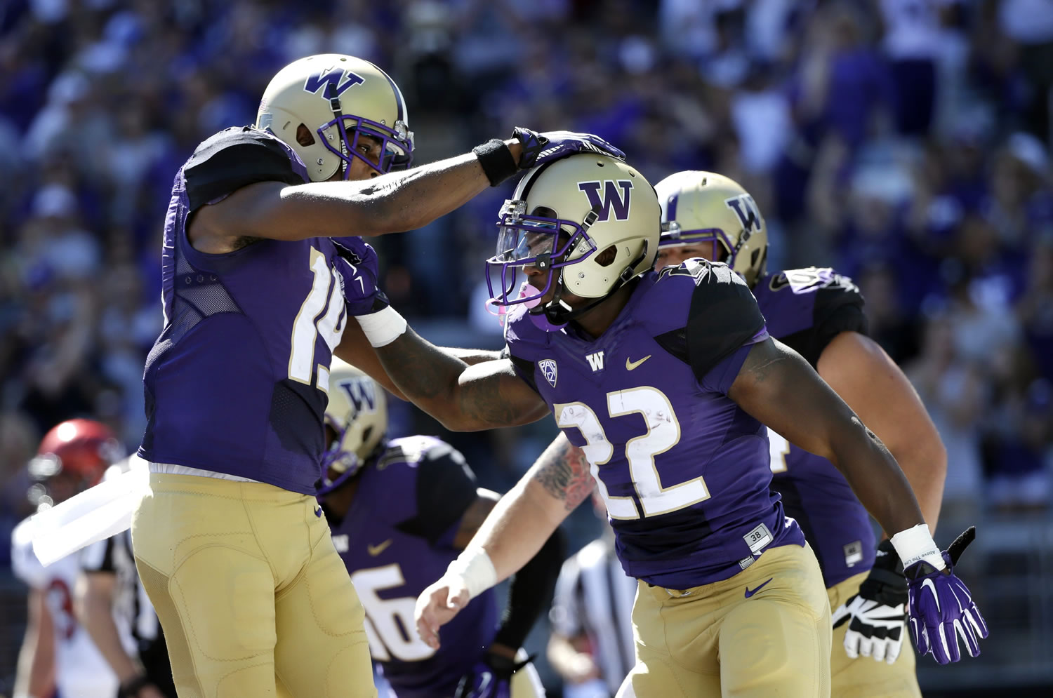 Washington Huskies running back Lavon Coleman (22) is congratulated after scoring against Eastern Washington in the first half of an NCAA football game Saturday, Sept. 6, 2014, in Seattle.