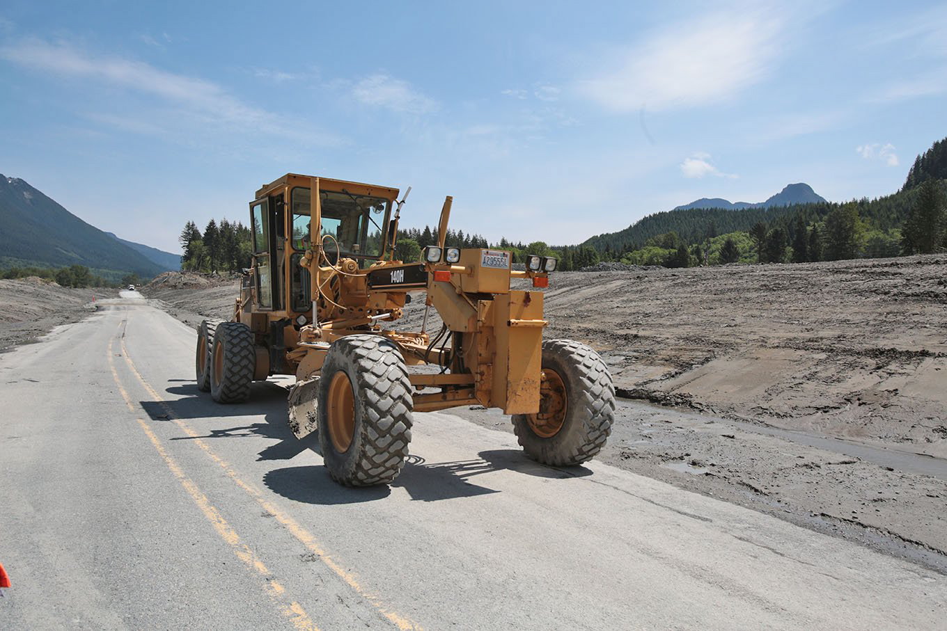 Road crews work to finish repair work on Highway 530 on Friday in Oso, which was buried in mud by a March 22 mudslide. The road will reopen today.