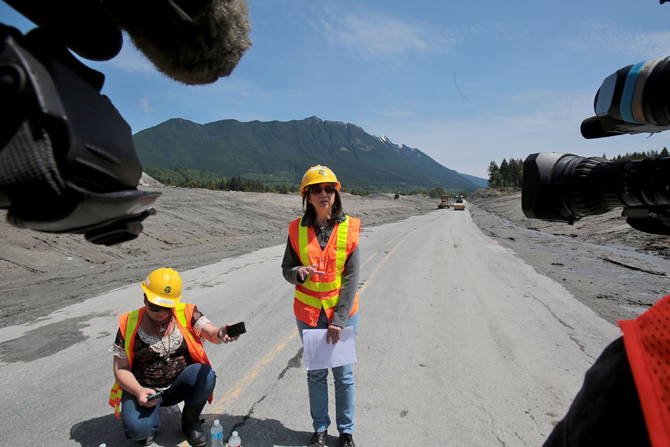 Lorena Eng, WSDOT Northwest Region Administrator, speaks to the media Friday as road crews work to finish repair work on Highway 530 in Oso, which was buried in mud by a March 22 mudslide. The road reopened Saturday at noon.