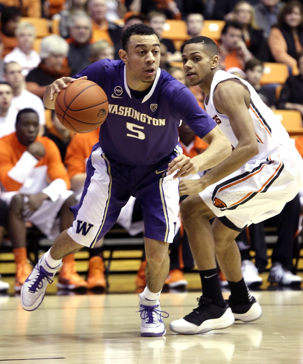 Washington guard Nigel Williams-Goss, left, drives to the hoop past Oregon State guard Hallice  Cooke during the first half Saturday. Williams-Goss had 14 points and 10 assists in the Huskies' 86-62 victory.