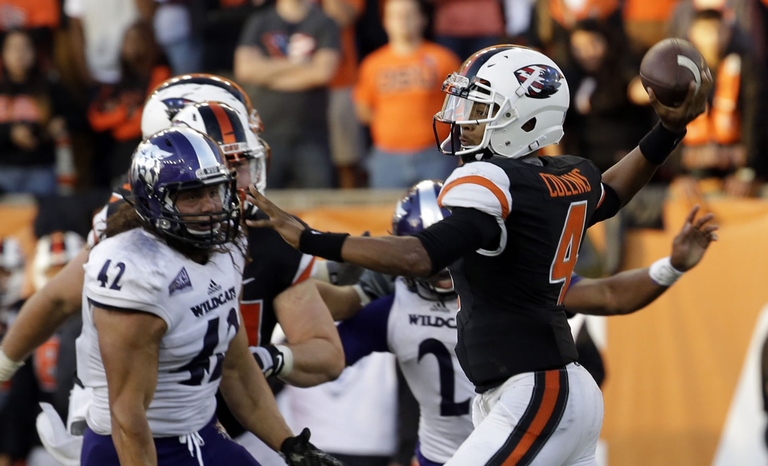 Oregon State quarterback Seth Collins, right, throws as Weber State defensive lineman Jonathan Carlson watches during the second half of an NCAA college football in Corvallis, Ore., Friday, Sept. 4, 2015. Oregon State won 26-7.