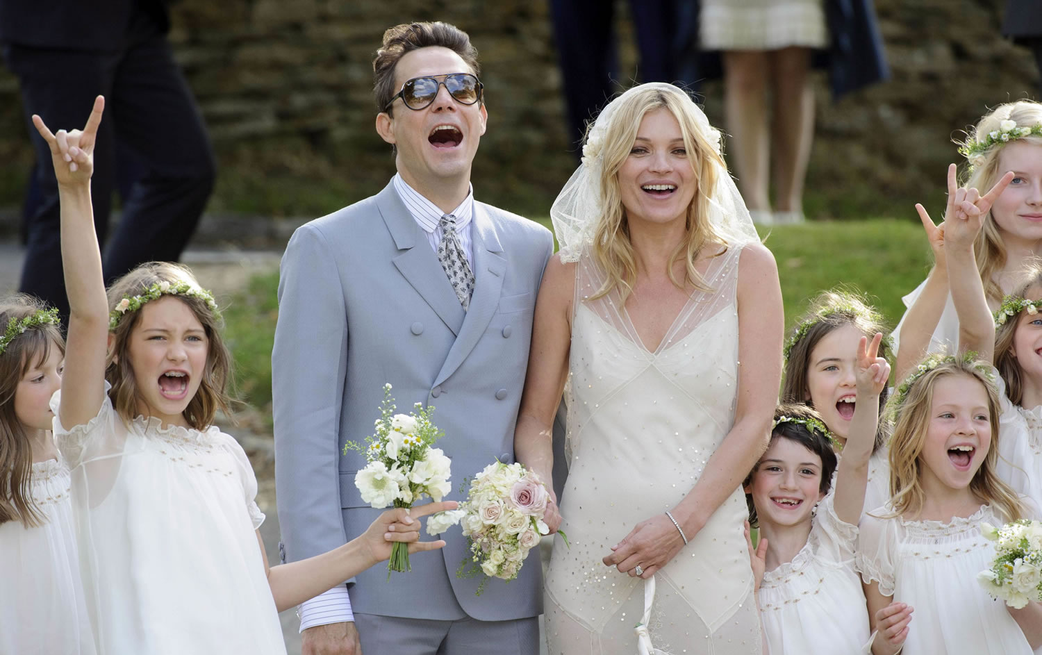 Assocaited Press files
British model Kate Moss and British guitarist Jamie Hince pose for photos with bridesmaids after their July 2011 wedding in Southrop, England.