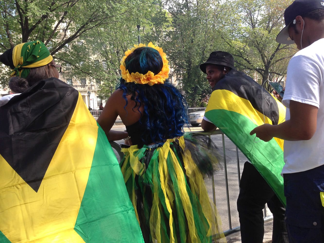 Spectators wearing the colors of the Jamaican flag wait behind barriers for the annual West Indian Day Parade to start along Brooklyn's Eastern Parkway in New York on Monday.