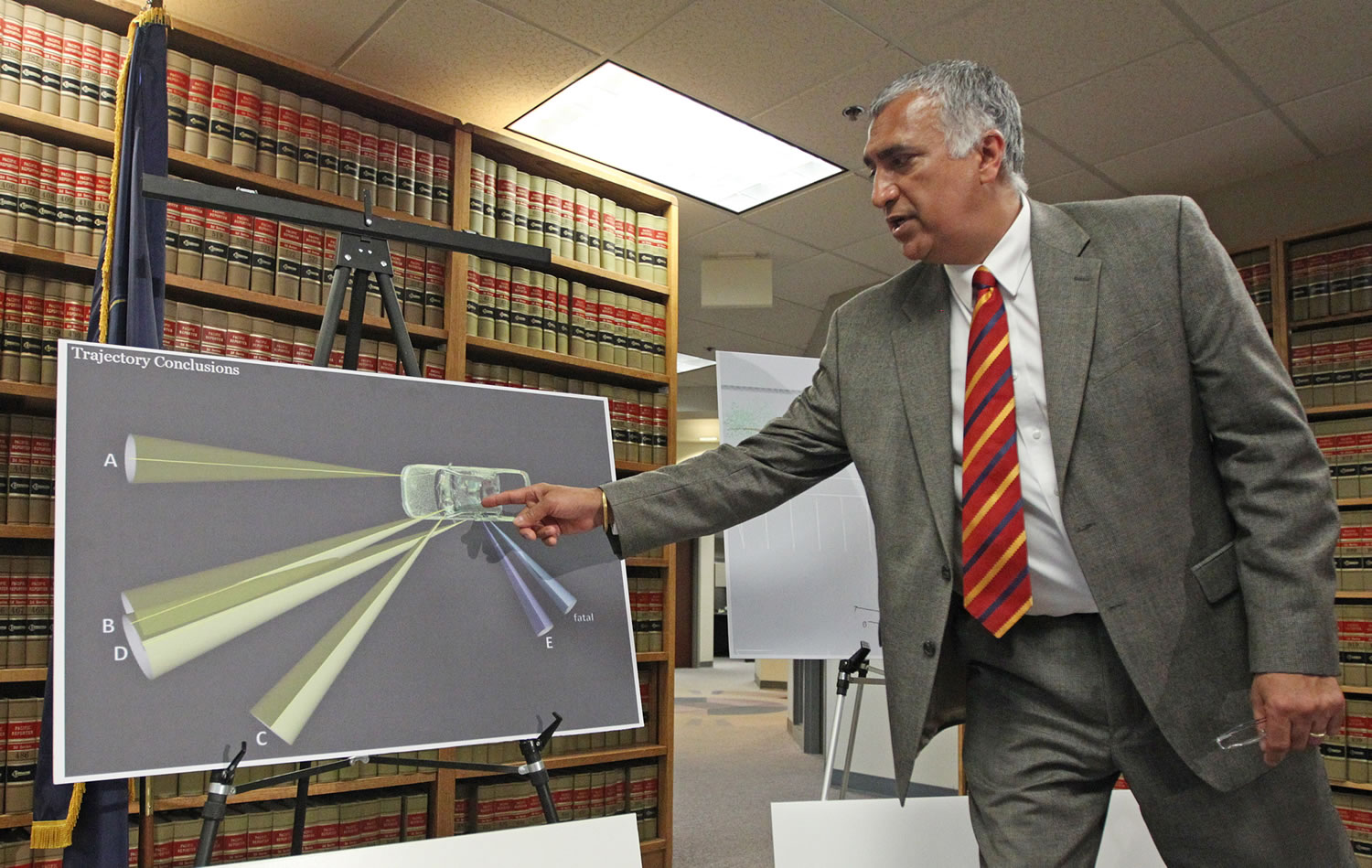 Salt Lake County District Attorney Sim Gill points out the angle trajectory of the fatal bullet, while discussing the findings of the investigation into the shooting of Danielle Willard during a news conference Aug. 8, in Salt Lake City. Gill announced that a single count of manslaughter had been filed against 33-year-old Shaun Cowley, a former narcotics officer in West Valley City on Thursday. Cowley and another officer fired at Danielle Willard as she backed her car out of a parking spot.