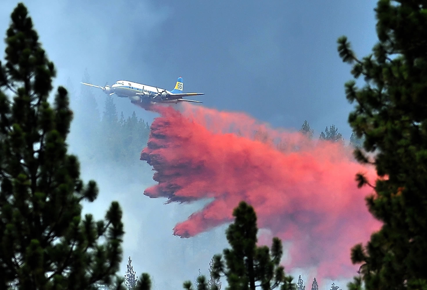 An air tanker drops fire retardant on the Rogue River Drive fire outside Shady Cove, Ore., on Tuesday.