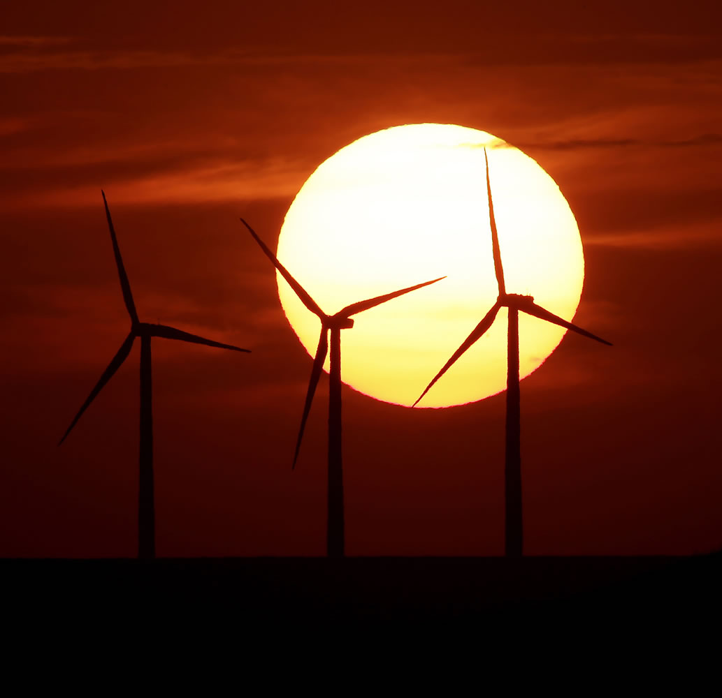 Wind turbines silhouetted by the setting sun near Beaumont, Kansas.