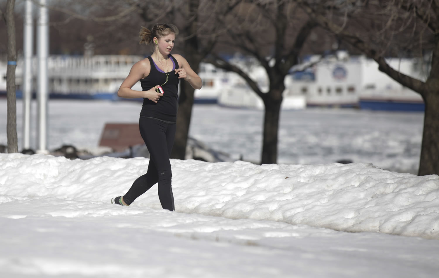 A runner runs along the lake shore Wednesday in Chicago.