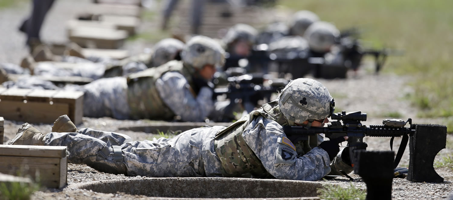 Female soldiers train on a firing range while wearing new body armor in Fort Campbell, Ky.
