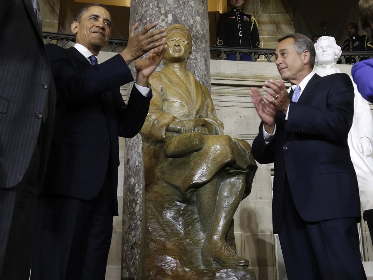 President Barack Obama and House Speaker John Boehner of Ohio applaud Feb. 27, 2013, at the unveiling of a statue of Rosa Parks on Capitol Hill in Washington.