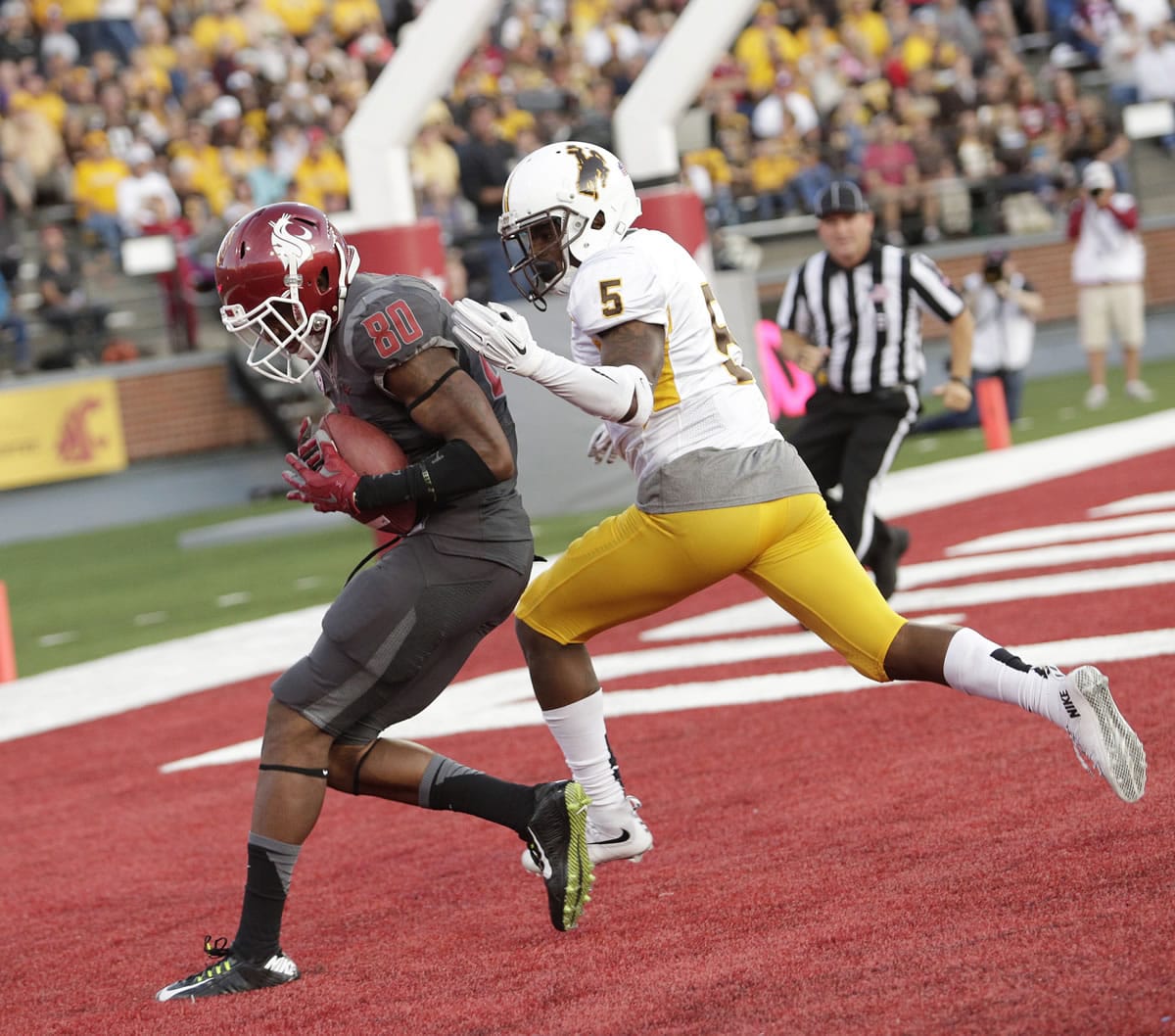 Washington State wide receiver Dom Williams (80) makes a catch for a touchdown against Wyoming cornerback Tyran Finley (5) during the first half Saturday, Sept. 19, 2015, in Pullman.