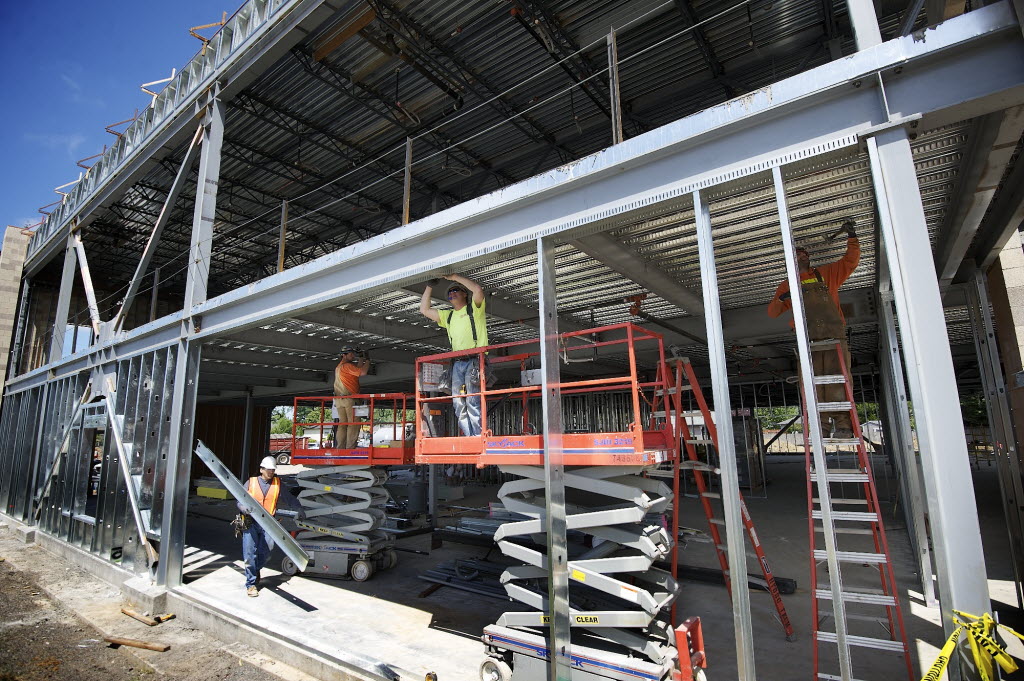 Construction workers with Harlen's Drywall of Vancouver install galvanized metal framing at a medical building under construction in Salmon Creek on June 3.
