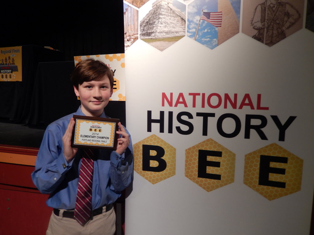 Eisenhower Elementary fifth-grader Andrew Douglas holds his award for winning the regional championship of the National History Bee.